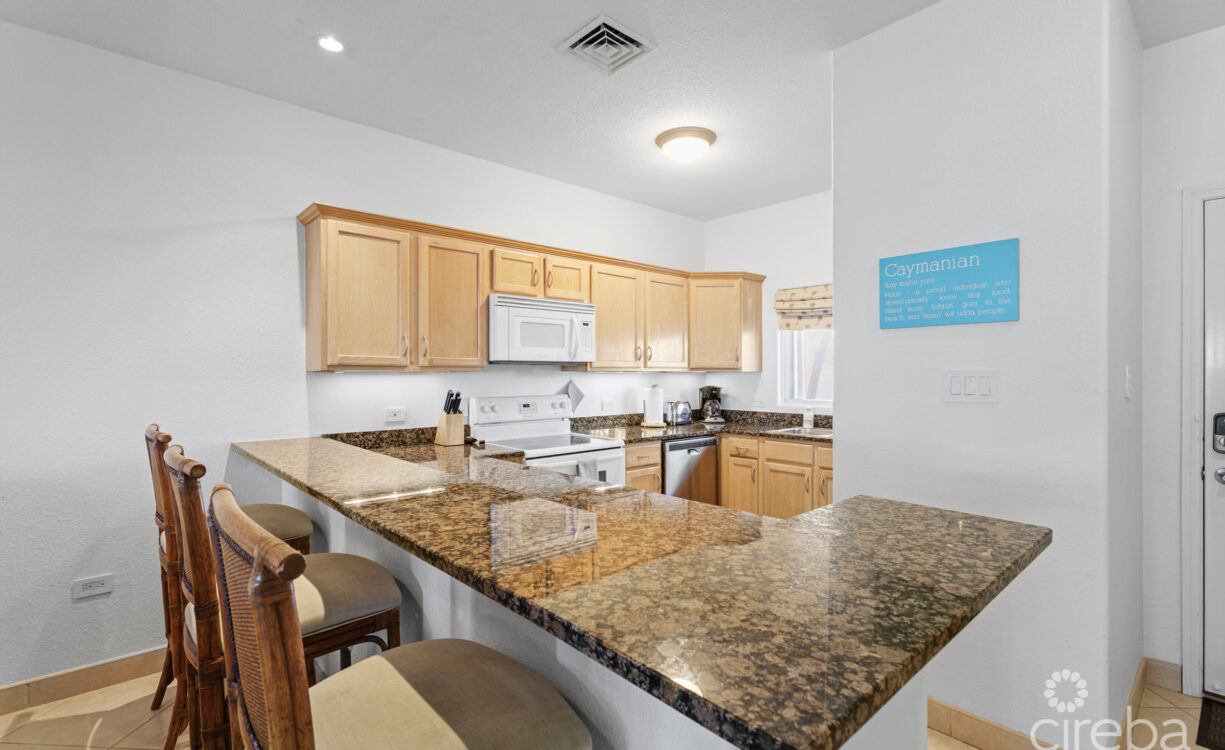 open kitchen with lots of cabinets and a breakfast bar